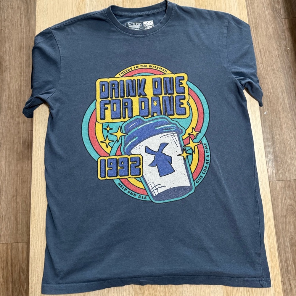 Dutch Bros Navy Graphic Tee with Yellow, Teal, Red and White Print